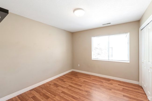 Unfurnished bedroom featuring light wood-type flooring and a closet | Image 13