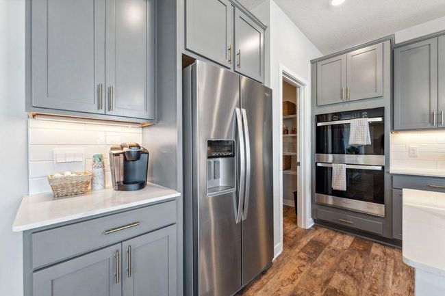 Upgraded Signature Kitchen includes: Double wall oven, gas cooktop, microwave w/air fryer and dishwasher. Jameson floor plan. Photo of previously built home; finishes, selections, colors, and floorplan to vary. | Image 6
