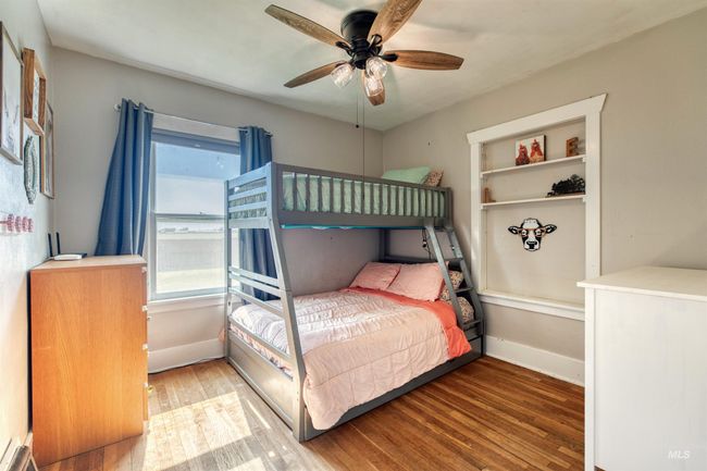 Bedroom with wood finished floors and a ceiling fan | Image 24