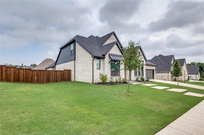 View of property exterior featuring a yard and a garage | Image 3