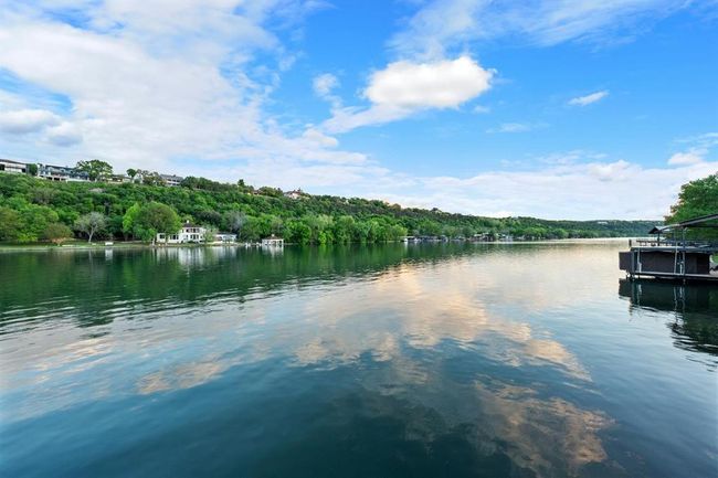 Water view featuring a heavily wooded area and a dock | Image 27