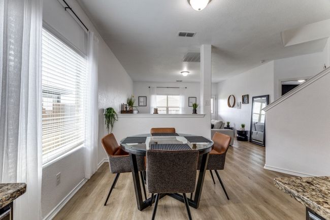 Dining room with light wood-style floors and baseboards | Image 16