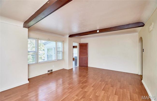 Living room featuring beam ceiling and light wood-type flooring | Image 6