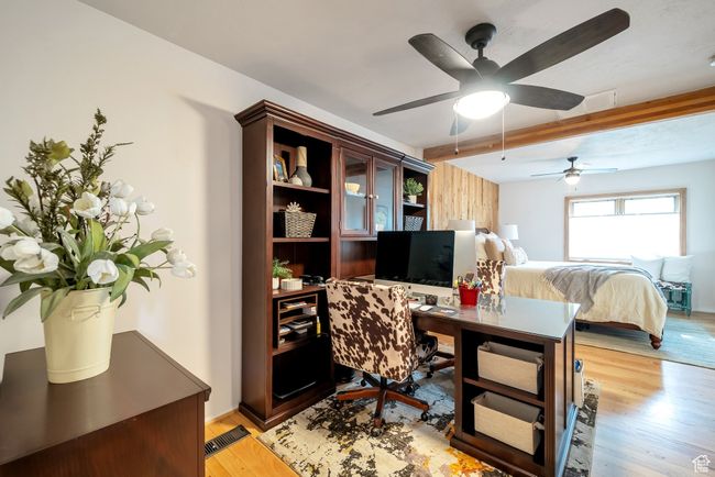 Home office with beam ceiling, a ceiling fan, and light wood-style flooring | Image 13