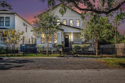 Welcome to this two-story, Craftsman-style home featuring a covered front and back porch, a fully fenced yard, and located on the mature tree-lined Rutland Street. | Image 1