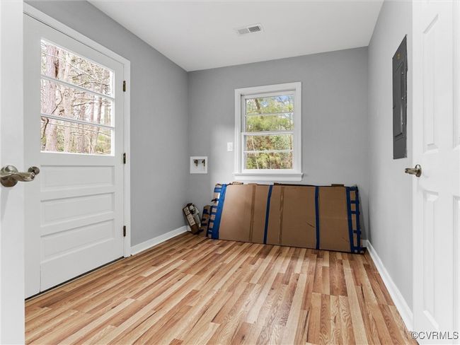 Laundry room with washer hookup, laundry area, visible vents, and light wood-style flooring | Image 13