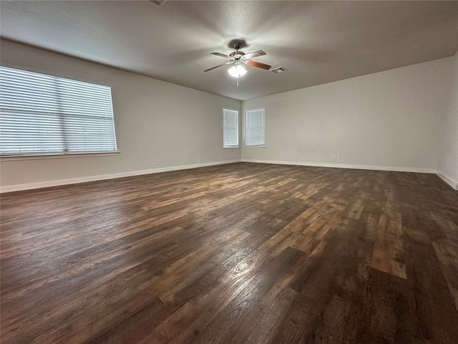 Spare room with dark wood-style floors and ceiling fan | Image 37