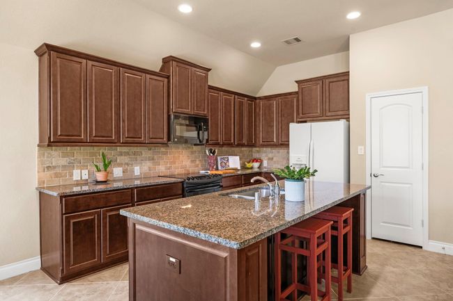 Island features bar seating. | Image 12