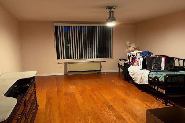 Bedroom with wood finished floors and baseboards | Image 4