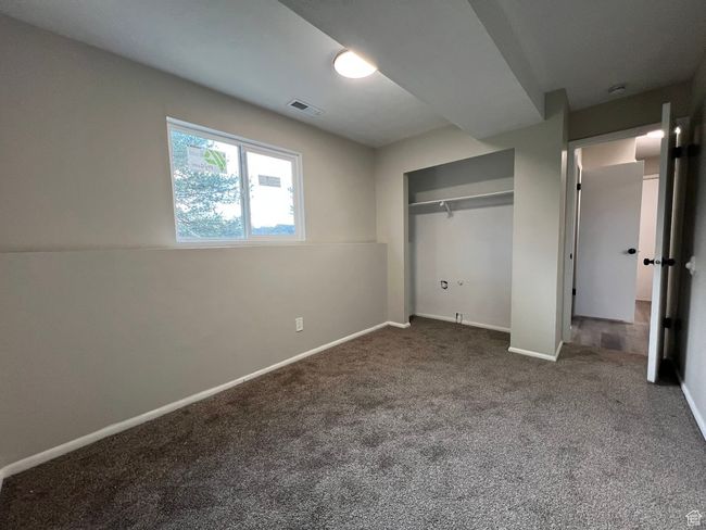 Unfurnished bedroom featuring a closet, visible vents, carpet, and baseboards | Image 8