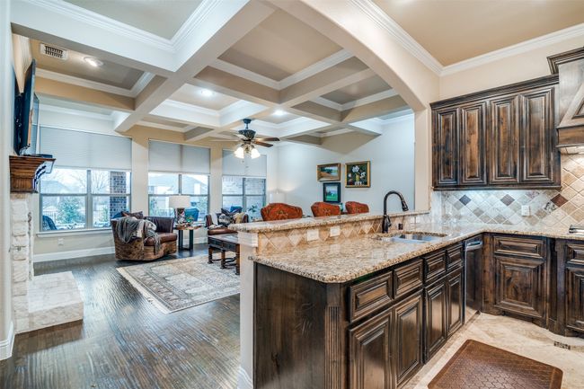 Kitchen featuring a designer tile backsplash, granite counter tops with double sinks and an oil-rubbed bronze faucet with pull down spray and reflex technology. | Image 14