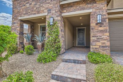 Entry porch area. Coach lights and paver pathway. | Image 3