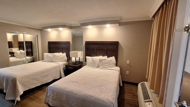 Bedroom with crown molding, dark wood-style flooring, a textured ceiling, and a wall mounted AC | Image 5