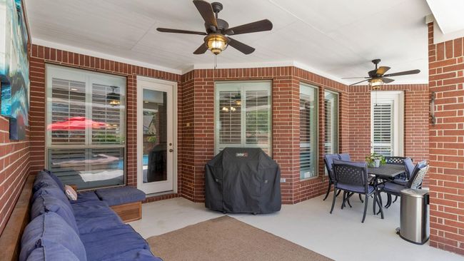 Huge covered patio over looking pool with beach like entry | Image 31