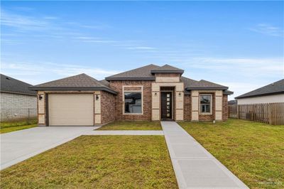 Prairie-style house featuring a garage and a front lawn | Image 1