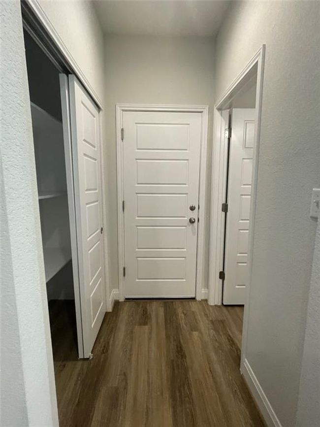Hall with dark wood-type flooring and baseboards | Image 14