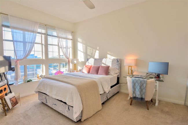 Bedroom featuring light colored carpet and ceiling fan | Image 36