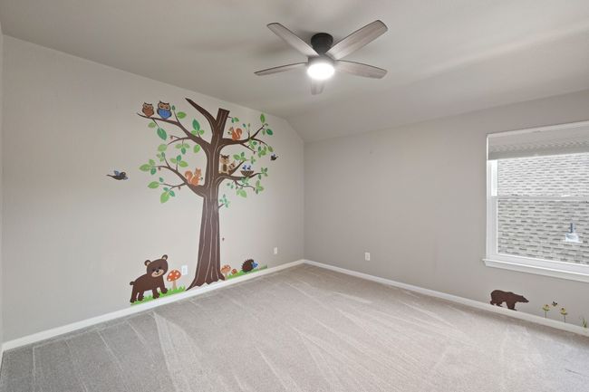 Unfurnished room with carpet, baseboards, a ceiling fan, and vaulted ceiling | Image 22
