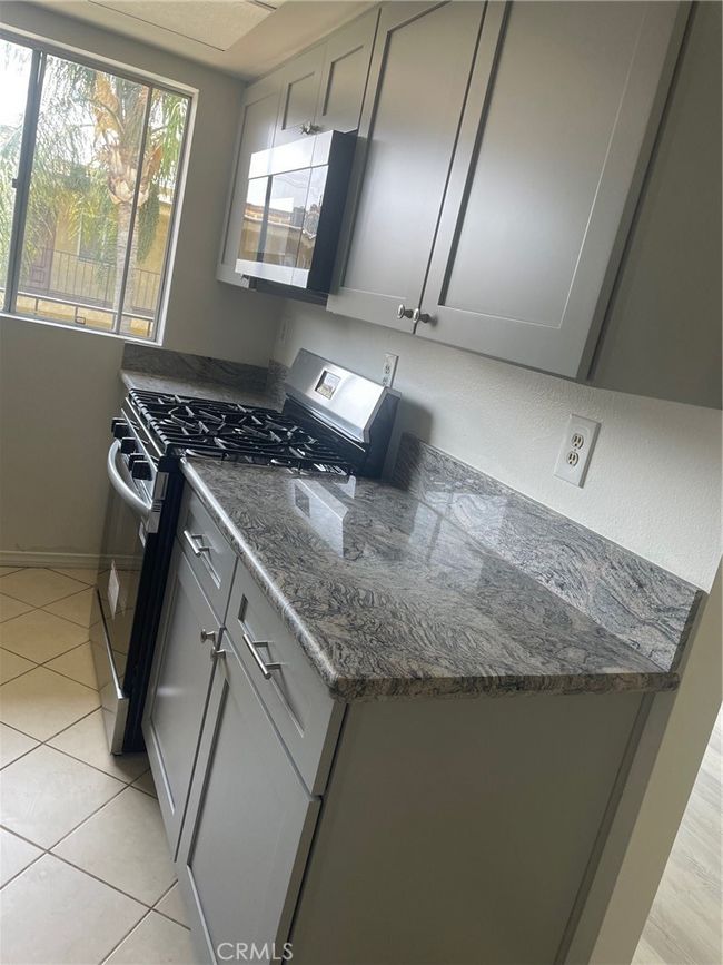 Kitchen with gas range and microwave | Image 6