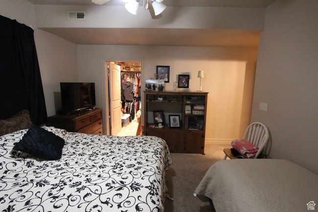 Bedroom with visible vents, a ceiling fan, carpet, a spacious closet, and a closet | Image 17