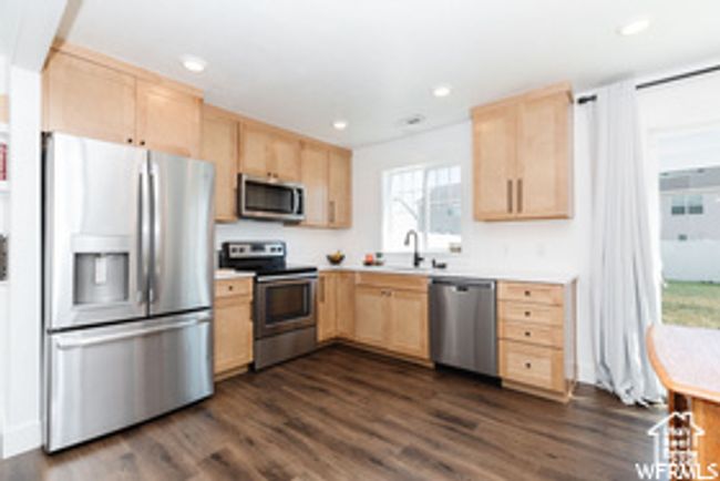 Kitchen featuring light brown cabinetry, appliances with stainless steel finishes, light countertops, and recessed lighting | Image 13