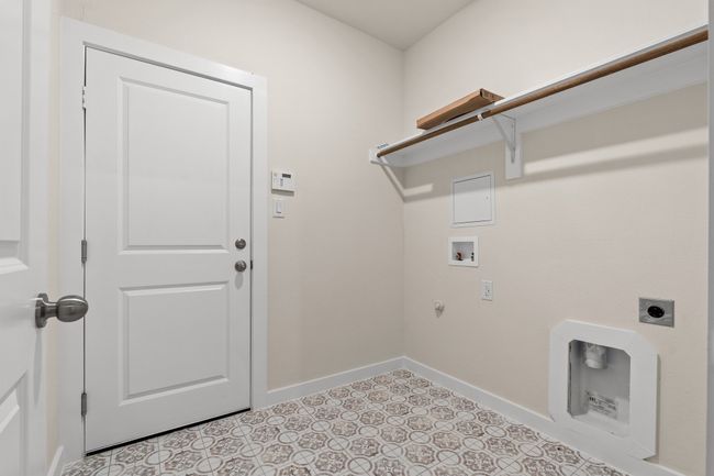Laundry area with electric dryer hookup, washer hookup, baseboards, and hookup for a gas dryer | Image 25