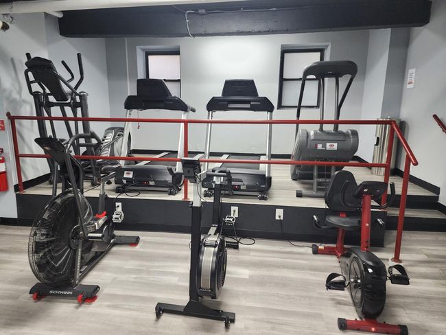 Workout area featuring wood finished floors and baseboards | Image 9