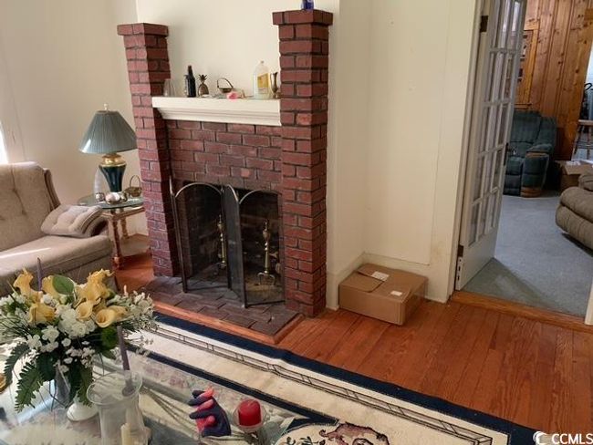 Living room with wood finished floors and a fireplace | Image 14