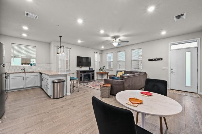 The cozy dining area is a inviting space, perfect for intimate meals or casual get-togethers, seamlessly flowing from the living room with easy access to the kitchen | Image 10