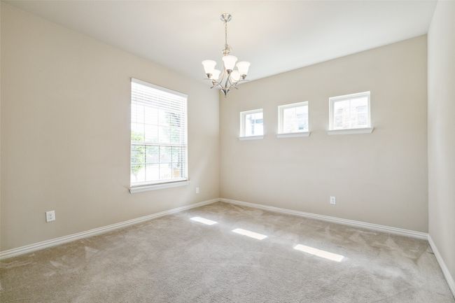 Unfurnished room with a chandelier, plenty of natural light, and carpet | Image 6