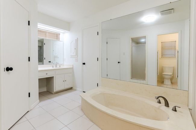 Full bath with visible vents, toilet, vanity, a stall shower, and tile patterned flooring | Image 23