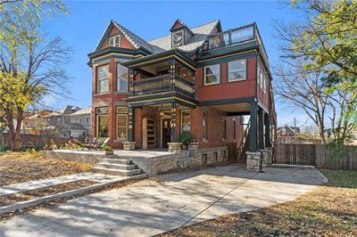 Victorian-style house featuring a patio area and a balcony | Image 3