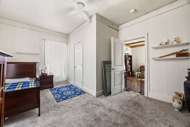 Bedroom with carpet floors, ornamental molding, and a ceiling fan | Image 20
