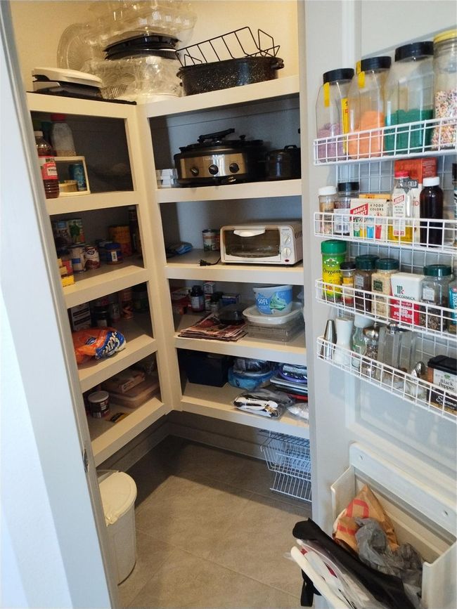 Large walk in pantry. Spice rack excluded. | Image 19
