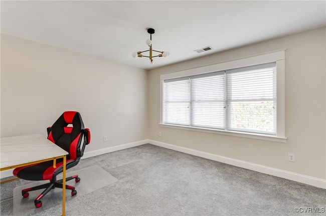 Unfurnished office featuring baseboards, visible vents, carpet, and a chandelier | Image 31