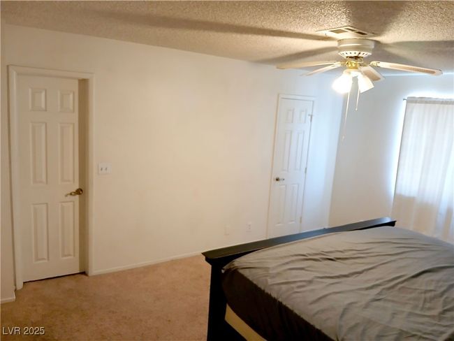 Bedroom featuring light carpet, ceiling​​‌​​​​‌​​‌‌​‌‌​​​‌‌​​‌‌​‌​​​​​‌ fan. | Image 7