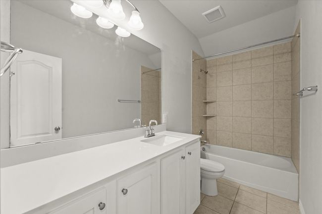 Bathroom featuring vanity and shower / tub combination | Image 29