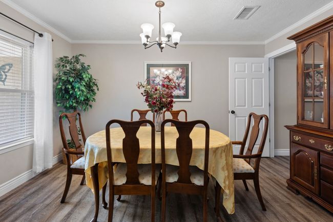 Dining area with a chandelier, wood finished floors, and ornamental molding | Image 22