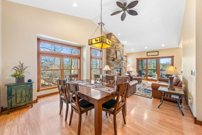 Warm and welcoming shared living/dining room with soaring vaulted ceiling. | Image 6