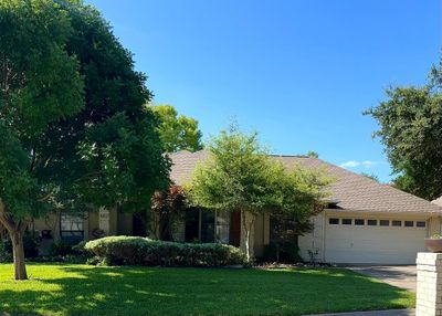 View of front of home with a lawn and a garage | Image 1