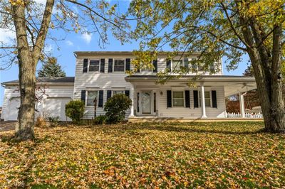 View of front facade with a front lawn and a garage | Image 1