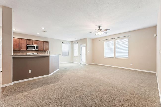 Enjoy some family time in the back room next to the kitchen and breakfast area | Image 12