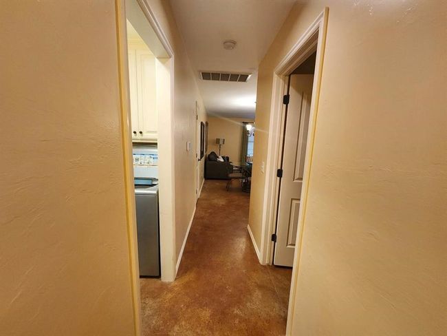 Hall featuring washer / clothes dryer and concrete floors | Image 17