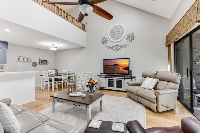 Living area featuring high vaulted ceiling, recessed lighting, light wood-style flooring, and a ceiling fan | Image 8
