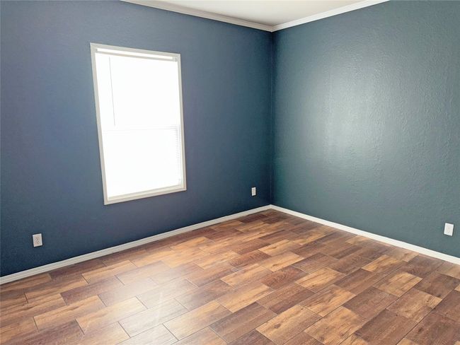 Empty room featuring wood finished floors and crown molding | Image 20