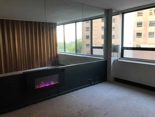 View of living room with reflection above the fire | Image 9