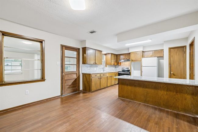 Breakfast room opens to cooking area in kitchen. Back door opens to covered enclosed patio | Image 12