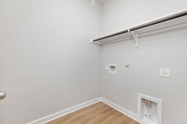 Washroom with laundry area, gas dryer hookup, hookup for a washing machine, light wood-style floors, and electric dryer hookup | Image 20