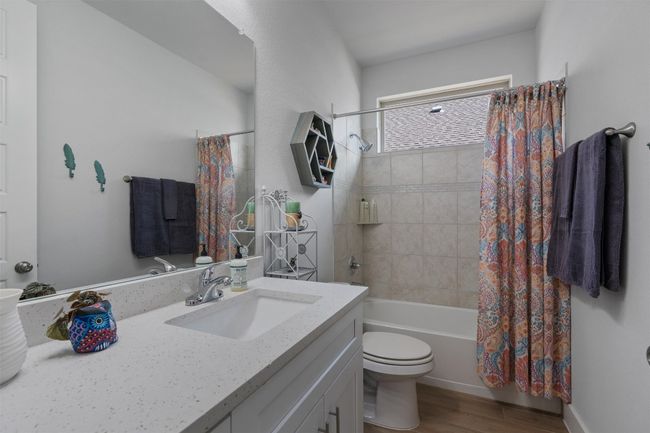 Full bathroom with vanity, toilet, wood finished floors, and shower / tub combo. | Image 23