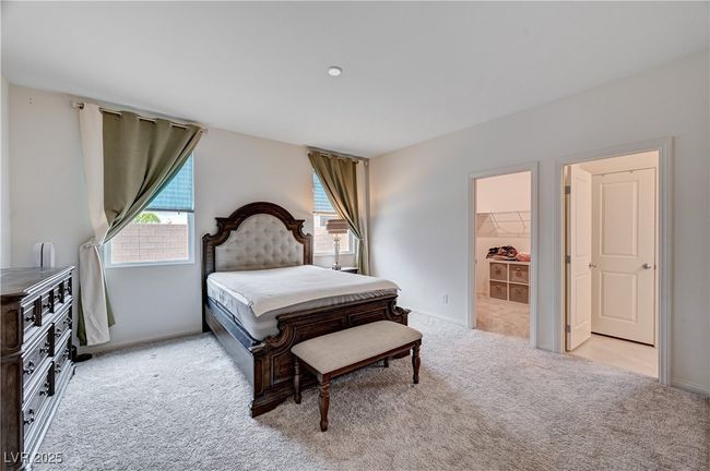 Bedroom featuring light carpet, baseboards, and a walk in closet | Image 19